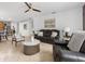 Cozy living room with comfortable leather seating and a ceiling fan for added comfort at 204 Cotswold Cir, Davenport, FL 33837