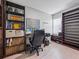 Spacious home office with shelving and large window providing plenty of natural light at 204 Cotswold Cir, Davenport, FL 33837