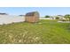Backyard shed in a fenced yard, offering ample storage space for your outdoor needs at 204 Cotswold Cir, Davenport, FL 33837