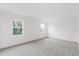 Bright bedroom featuring gray carpet, two windows, and minimalist aesthetic at 2261 Sirena Ln, Mount Dora, FL 32757