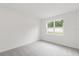 Simple bedroom with neutral carpet, white walls, and a bright window view at 2261 Sirena Ln, Mount Dora, FL 32757