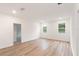 Spacious bedroom with wood flooring, bright natural light, and minimalist decor at 2261 Sirena Ln, Mount Dora, FL 32757