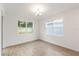 The dining room features natural light with two large windows and neutral paint and flooring at 2261 Sirena Ln, Mount Dora, FL 32757