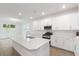 Bright, open kitchen features white cabinets, an island, and stainless steel appliances at 2261 Sirena Ln, Mount Dora, FL 32757