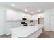 Well-lit kitchen with a large island, stainless steel appliances, and white cabinetry at 2261 Sirena Ln, Mount Dora, FL 32757
