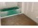 Unfinished bathroom featuring tile walls and a colored tub at 2379 Broadbrook Drive, St Cloud, FL 34771