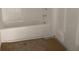 An unfinished bathroom featuring a white tub and tiled walls at 2379 Broadbrook Drive, St Cloud, FL 34771