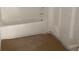 An unfinished bathroom featuring a white tub and tiled walls at 2379 Broadbrook Drive, St Cloud, FL 34771