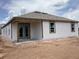 New construction home with a back patio, freshly installed siding, and visible framing materials at 2379 Broadbrook Drive, St Cloud, FL 34771