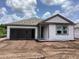 New home featuring an attached garage and gray vinyl siding at 2379 Broadbrook Drive, St Cloud, FL 34771
