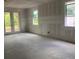 Unfinished interior featuring drywall, two windows, and access to the outdoors at 2379 Broadbrook Drive, St Cloud, FL 34771