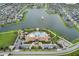 This stunning aerial view features a lake, community pool, clubhouse, and plentiful parking at 2696 Giardino Loop, Kissimmee, FL 34741