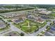 Aerial view of a neighborhood featuring a central park, playgrounds, and walking paths at 2696 Giardino Loop, Kissimmee, FL 34741