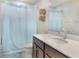 Bright bathroom with a modern vanity, toilet, and bathtub with a shower curtain at 2696 Giardino Loop, Kissimmee, FL 34741
