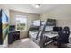 Functional bedroom featuring a bunk bed, desk, and window for natural light, creating a versatile space at 2696 Giardino Loop, Kissimmee, FL 34741