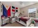 Comfortable bedroom with flags, a window providing natural light, a desk, and ample space at 2696 Giardino Loop, Kissimmee, FL 34741