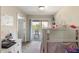 Cozy bedroom featuring a bed, dresser, and sliding glass door leading to a balcony at 2696 Giardino Loop, Kissimmee, FL 34741