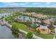 Aerial view of the community pool, playground, and lake in this residential area at 2696 Giardino Loop, Kissimmee, FL 34741