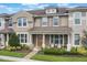 Charming two-story home with a covered front porch, well-maintained landscaping, and neutral-toned exterior at 2696 Giardino Loop, Kissimmee, FL 34741