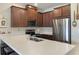 Well-equipped kitchen with stainless steel appliances, ample counter space, and rich wood cabinetry at 2696 Giardino Loop, Kissimmee, FL 34741