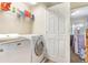 Functional laundry room equipped with a washer, dryer, and storage shelves at 2696 Giardino Loop, Kissimmee, FL 34741