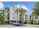 Beautiful condo building featuring tropical landscaping and ample parking spaces at 300 Carolina Ave # 205, Winter Park, FL 32789