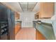 Efficient kitchen layout with wood cabinetry and tile flooring at 300 Carolina Ave # 205, Winter Park, FL 32789