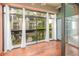 Relaxing enclosed lanai with wood flooring and serene outdoor views at 300 Carolina Ave # 205, Winter Park, FL 32789