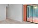 Spacious living room featuring neutral carpet and sliding glass doors to the outdoor patio at 300 Carolina Ave # 205, Winter Park, FL 32789