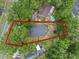 Aerial view of property, surrounded by lush trees, shows the house's roof and backyard at 30926 County Road 435, Sorrento, FL 32776