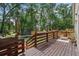 Inviting back deck with wood railing, string lights, and outdoor seating provides a relaxing space at 30926 County Road 435, Sorrento, FL 32776