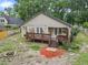 Large backyard featuring a wooden deck, fire pit, and lush greenery offers an inviting outdoor space at 30926 County Road 435, Sorrento, FL 32776