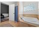 Bright bathroom features a soaking tub and access to the main bedroom at 30926 County Road 435, Sorrento, FL 32776