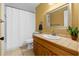 Bathroom featuring a single sink vanity, toilet, tile flooring, and shower at 30926 County Road 435, Sorrento, FL 32776