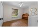 Cozy bedroom with hardwood floors, a ceiling fan, and a wooden crib at 30926 County Road 435, Sorrento, FL 32776