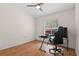 Bright bedroom features hardwood flooring, a fan, and workstation near the window at 30926 County Road 435, Sorrento, FL 32776