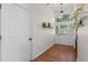 Bright entryway featuring hardwood floors, a decorative light fixture, and a view of the front door at 30926 County Road 435, Sorrento, FL 32776