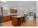 Spacious kitchen with hardwood floors, an island with seating, and an open view to the living room at 30926 County Road 435, Sorrento, FL 32776