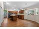 Open kitchen with hardwood floors, an island with seating, and modern appliances at 30926 County Road 435, Sorrento, FL 32776