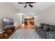 Open-concept living room flows into kitchen with ceiling fan and wood floors at 30926 County Road 435, Sorrento, FL 32776