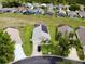Aerial view of home with solar panels, screened pool, manicured lawn, and cul-de-sac street at 318 Langham Dr, Davenport, FL 33897