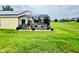 Screened-in lanai with lovely landscaped yard and view of golf course at 318 Langham Dr, Davenport, FL 33897