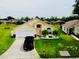 Charming single-Gathering home with a well-maintained lawn, a two-car garage, and lush landscaping at 318 Langham Dr, Davenport, FL 33897