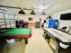 Finished garage featuring an air hockey table, pool table, dart board, and ample storage at 318 Langham Dr, Davenport, FL 33897