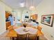 Eat-in kitchen featuring tile floors, ample counter space, light wood cabinetry, and stainless appliances at 318 Langham Dr, Davenport, FL 33897