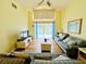 Bright living room with vaulted ceilings and sliding glass doors to the screened-in pool at 318 Langham Dr, Davenport, FL 33897