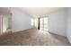Spacious bedroom with neutral walls and carpet, featuring a sliding glass door to a private balcony at 3748 Idlebrook Cir # 202, Casselberry, FL 32707