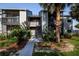Exterior of a condo building with beautiful landscaping and a well-maintained walkway at 3748 Idlebrook Cir # 202, Casselberry, FL 32707