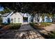Charming building exterior with beautiful landscaping and shaded walkway, enhancing the neighborhood's appeal at 3748 Idlebrook Cir # 202, Casselberry, FL 32707