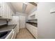 Well-maintained kitchen with white cabinets, functional appliances, and durable tile floors for easy upkeep at 3748 Idlebrook Cir # 202, Casselberry, FL 32707